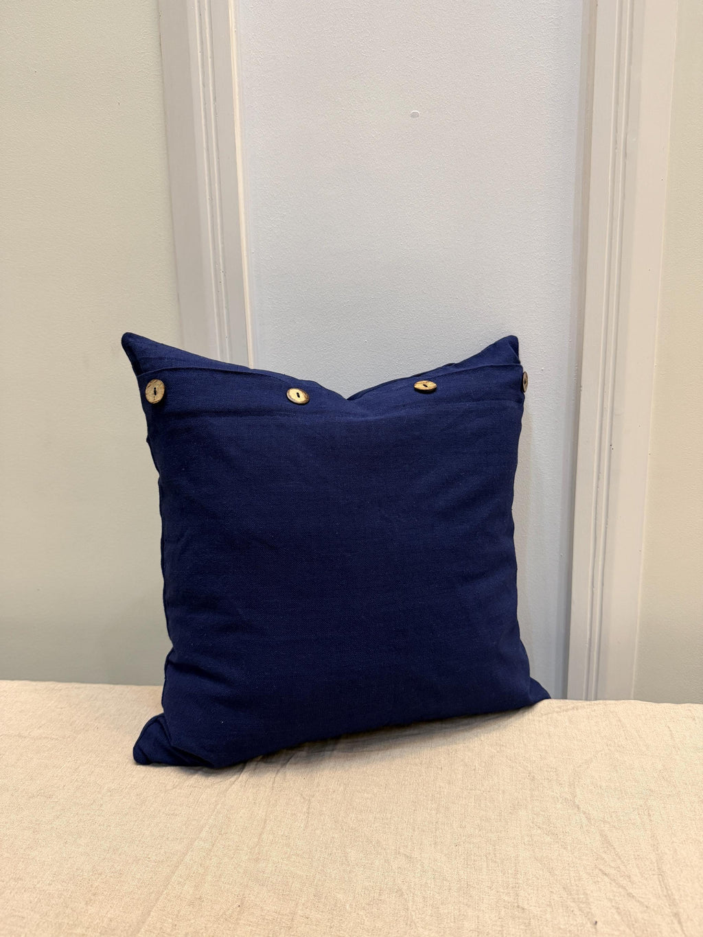Navy blue linen pillow cover with wooden buttons
